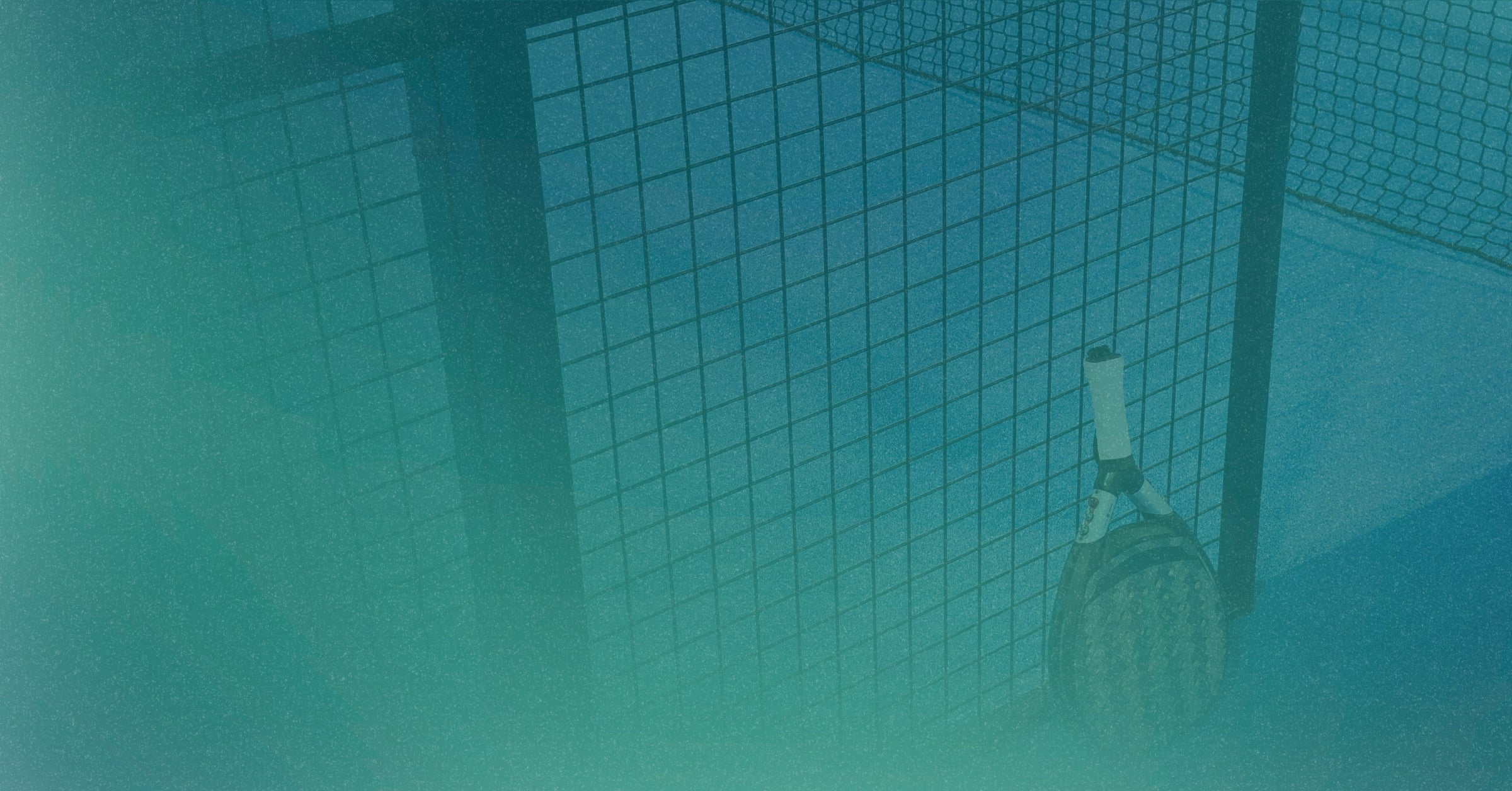 padel racket inside a wire cage with a blue tint