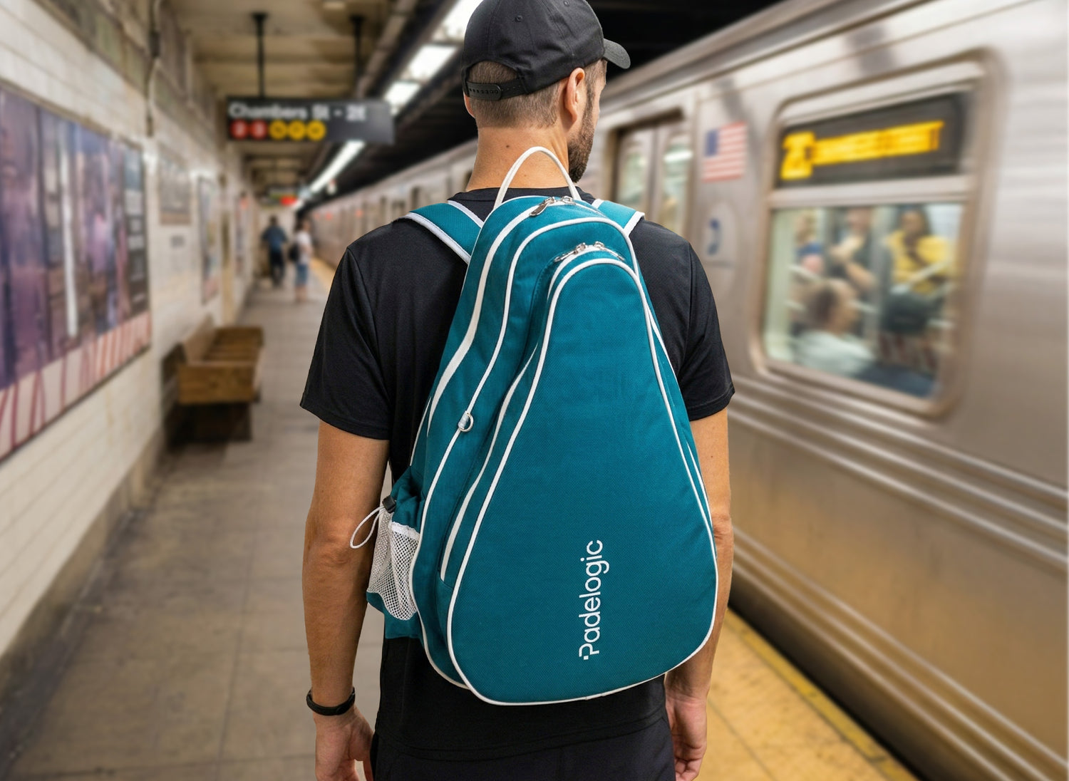 Person with a teal padel backpack standing on a subway platform